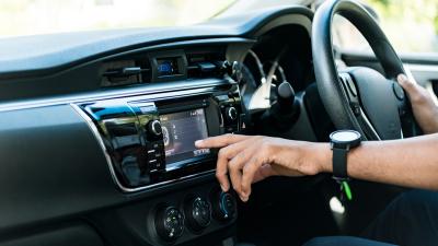 View of the console of a car as the driver adjust settings on a display